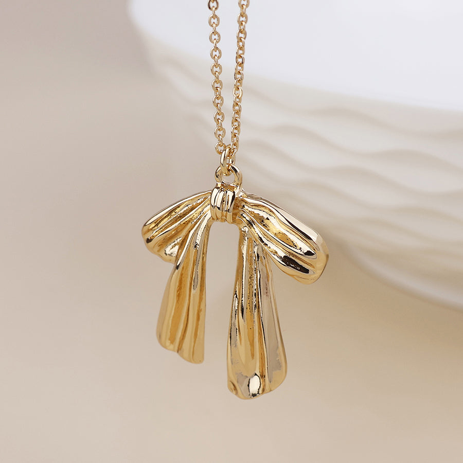 POM Colette Gold-Tone polished bow necklace