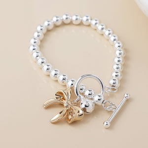 POM Silver Plated Bell & Golden Bow Charm Bracelet - More Than Just a Gift | Narborough Hall