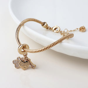 POM Golden Crystal Paw, Bone & Heart Print Charm Bracelet - More Than Just a Gift | Narborough Hall