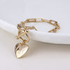 POM Foundry Gold-Tone heart and t-bar bracelet with twist links