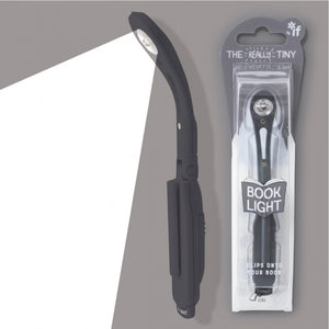 Black book light with packaging labeled 'The Really Tiny Booklight' on a gray background.