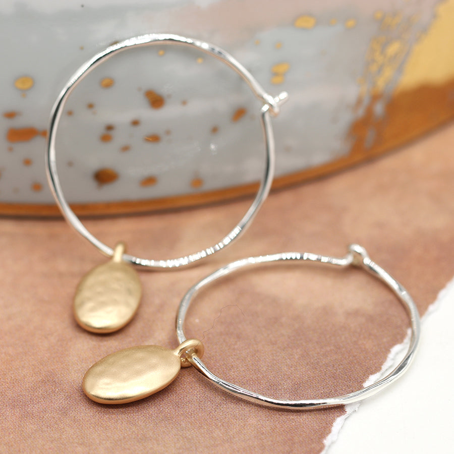POM Silver Plated Hammerd Hoop And Textured Golden Pebble Charm Earrings